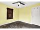 Bedroom featuring yellow walls, a ceiling fan, and hardwood floors at 1523 E Mills Ave, Indianapolis, IN 46227