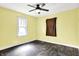 Bright bedroom featuring a ceiling fan, wood floors, and natural light from the window at 1523 E Mills Ave, Indianapolis, IN 46227