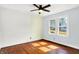 Bright bedroom with ceiling fan and hardwood floors at 1523 E Mills Ave, Indianapolis, IN 46227