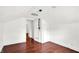 An attic bedroom with dark wood floors, a white ceiling, and white walls at 1523 E Mills Ave, Indianapolis, IN 46227