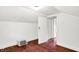 An empty bedroom with hardwood floors, white walls, and an air conditioner at 1523 E Mills Ave, Indianapolis, IN 46227