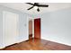 Sunny bedroom with hardwood floors, ceiling fan, and closet at 1523 E Mills Ave, Indianapolis, IN 46227