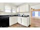 Efficient kitchen with white cabinets and standard-sized appliances at 1523 E Mills Ave, Indianapolis, IN 46227