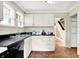 Corner kitchen with black countertop and appliances at 1523 E Mills Ave, Indianapolis, IN 46227