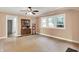 Bright living room with ceiling fan, three windows, and adjacent doorway at 1523 E Mills Ave, Indianapolis, IN 46227