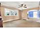 Bright living room with three windows and open doorway to the next room at 1523 E Mills Ave, Indianapolis, IN 46227