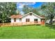 Home featuring a ramp, white siding, and well-maintained lawn, perfect for outdoor enjoyment at 1523 E Mills Ave, Indianapolis, IN 46227