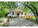 Rear exterior with wooden access ramp, white siding, and a spacious yard, creating a welcoming outdoor space at 1523 E Mills Ave, Indianapolis, IN 46227