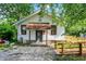 Cozy home featuring a wooden ramp, white siding, and a well-maintained gravel yard at 1523 E Mills Ave, Indianapolis, IN 46227