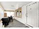 Enclosed sunroom area with bright windows, white walls, and ample space, enhancing the home's versatility at 1523 E Mills Ave, Indianapolis, IN 46227