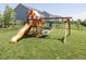 Spacious backyard featuring a wooden playset, swing set, and fenced perimeter at 16419 Connolly Dr, Westfield, IN 46074