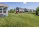 Large backyard with wooden playset, swing set and dark metal fence at 16419 Connolly Dr, Westfield, IN 46074