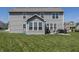 Lush backyard featuring a patio with seating, play set, and well-maintained lawn at 16419 Connolly Dr, Westfield, IN 46074