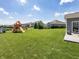 Expansive backyard with green grass, wooden playset and swing set at 16419 Connolly Dr, Westfield, IN 46074