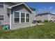 Side view of backyard with siding, deck, and lawn at 16419 Connolly Dr, Westfield, IN 46074