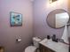 Stylish powder room features a modern vanity, sleek mirror, and colorful artwork at 16419 Connolly Dr, Westfield, IN 46074