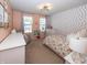 Bright bedroom with polka dot accent wall, stylish light fixture and decor at 16419 Connolly Dr, Westfield, IN 46074