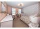 Cheerful bedroom with unique polka dot accent wall, stylish furnishings, and plenty of natural light at 16419 Connolly Dr, Westfield, IN 46074