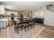 Bright dining room features an elegant rug, stylish decor, and seamless flow to the adjacent kitchen at 16419 Connolly Dr, Westfield, IN 46074