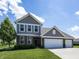Charming two-story home with brick accents, a well-manicured lawn, and attached garage at 16419 Connolly Dr, Westfield, IN 46074