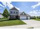 Charming two-story home with a well-manicured lawn, brick accents, and a three-car garage at 16419 Connolly Dr, Westfield, IN 46074