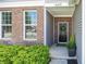 Close-up of front door with brick and vinyl siding, a wreath, and a welcoming entrance at 16419 Connolly Dr, Westfield, IN 46074