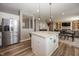 Open kitchen with stainless steel appliances, island with seating, and adjacent living space at 16419 Connolly Dr, Westfield, IN 46074