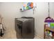 Convenient laundry area features modern washer and dryer, plus storage shelving at 16419 Connolly Dr, Westfield, IN 46074
