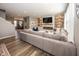 Comfortable living room with modern fireplace, large sectional couch, and bright natural light at 16419 Connolly Dr, Westfield, IN 46074