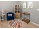 Cozy living room featuring a plush chair, wet bar, and decorative rug at 16419 Connolly Dr, Westfield, IN 46074