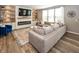 Modern living room with an electric fireplace, large couch and bright windows at 16419 Connolly Dr, Westfield, IN 46074