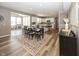 Open-concept living area with dining table, and views of the modern kitchen and playroom space at 16419 Connolly Dr, Westfield, IN 46074