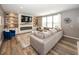 Inviting living room features a cozy fireplace, built-in shelves, and a large sectional couch at 16419 Connolly Dr, Westfield, IN 46074