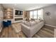 Inviting living room features a cozy fireplace, built-in shelves, and a large sectional couch at 16419 Connolly Dr, Westfield, IN 46074