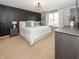 Serene main bedroom with dark accent wall, plush bedding, and natural light for a calming retreat at 16419 Connolly Dr, Westfield, IN 46074
