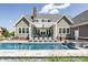 Stunning backyard view of an in-ground pool, outdoor lounge, and manicured lawn at 1799 Hourglass Dr, Carmel, IN 46032