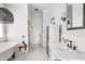 Stylish bathroom with a freestanding tub, black faucet, hanging light fixture, and a small stool with an orchid at 1799 Hourglass Dr, Carmel, IN 46032