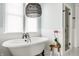 Elegant bathroom featuring a freestanding tub with a black faucet, a stool with an orchid, and a walk-in shower at 1799 Hourglass Dr, Carmel, IN 46032