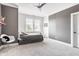 Contemporary bedroom features grey accent walls, a bed with storage, and modern decor for comfort at 1799 Hourglass Dr, Carmel, IN 46032