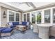 Comfortable covered patio with ceiling fan, wicker furniture and dining table at 1799 Hourglass Dr, Carmel, IN 46032