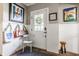 Bright entryway with wainscoting, a door with sidelights, a chair, hooks with bags, and artwork for a welcoming feel at 1799 Hourglass Dr, Carmel, IN 46032