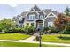 Inviting two-story gray home with manicured lawn, front porch, and blue front door at 1799 Hourglass Dr, Carmel, IN 46032
