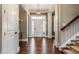 Elegant foyer with hardwood floors, white trim, and a view of the front door at 1799 Hourglass Dr, Carmel, IN 46032