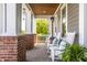 Relaxing covered front porch with rocking chairs, wood ceiling and brick columns at 1799 Hourglass Dr, Carmel, IN 46032