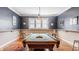 Bright game room with a pool table, natural light, and simple decor at 1799 Hourglass Dr, Carmel, IN 46032