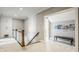 Upstairs hallway with carpet, wooden banister, white trim, storage cabinets, and an open doorway to another area at 1799 Hourglass Dr, Carmel, IN 46032