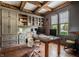 Spacious home office with rustic desk, wood ceiling beams, custom built-ins, and two large windows at 1799 Hourglass Dr, Carmel, IN 46032
