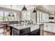 Open kitchen with island, stainless steel dishwasher, pendant lighting, and eat-in breakfast nook at 1799 Hourglass Dr, Carmel, IN 46032