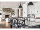 Stylish kitchen island featuring a marble countertop, pendant lighting, and view of the living room fireplace at 1799 Hourglass Dr, Carmel, IN 46032