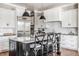 Bright kitchen featuring white cabinets, stainless steel appliances, and an island with bar stool seating at 1799 Hourglass Dr, Carmel, IN 46032